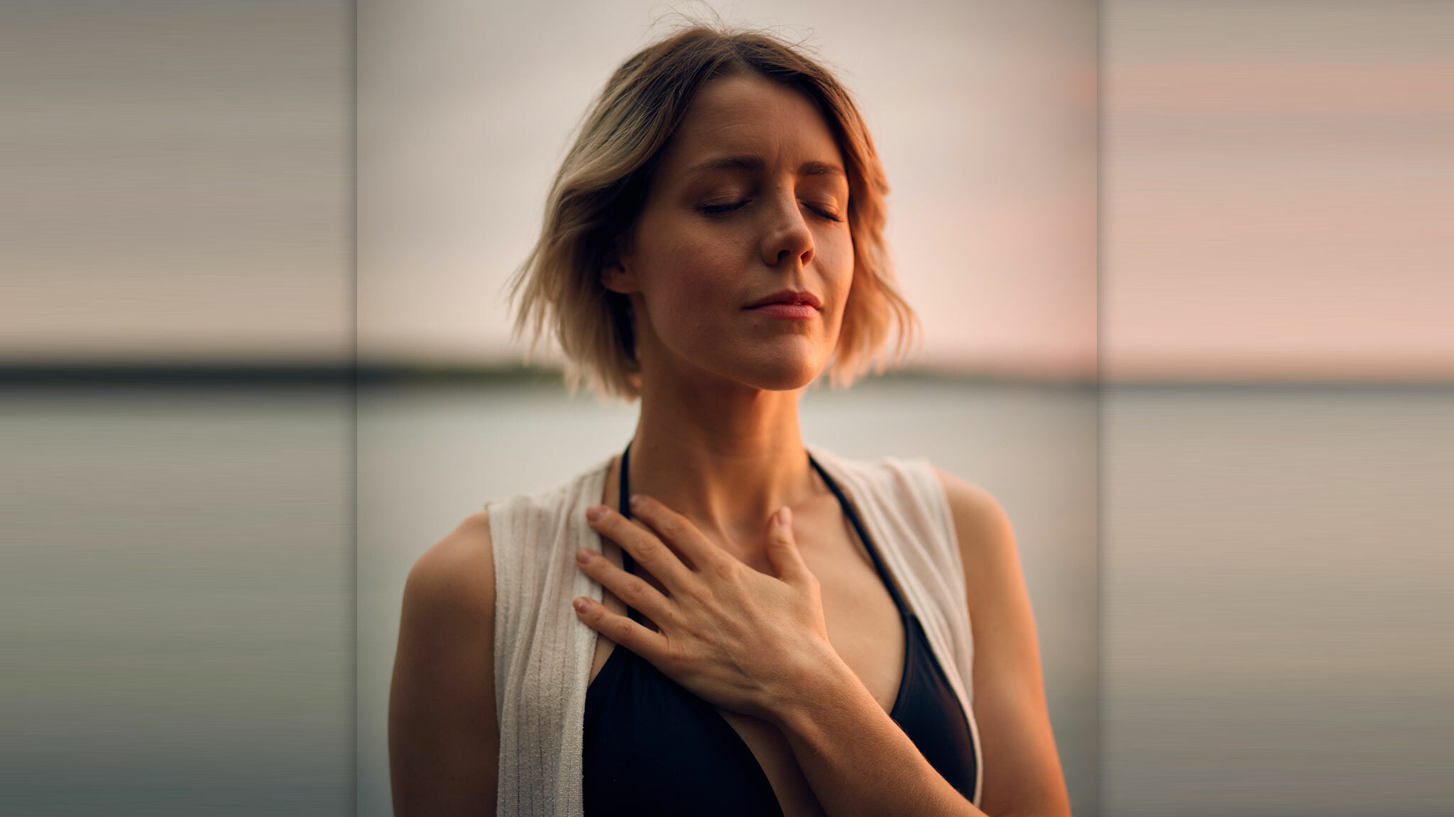 image of a lonely woman with eyes closed, a hand on her chest, realizing that she is lonely in her marriage