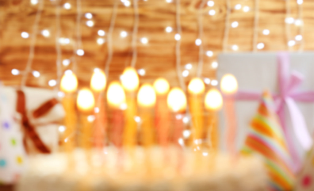 Blurry Image Of Candles On A Birthday Cake