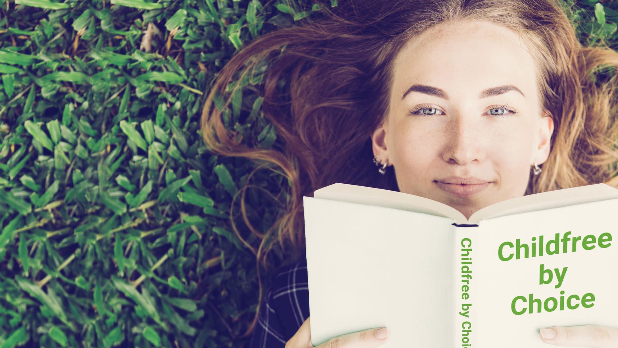 Woman Lying On Grass Holding A Book In Front Of Her Face That Reads: "Childfree By Choice"