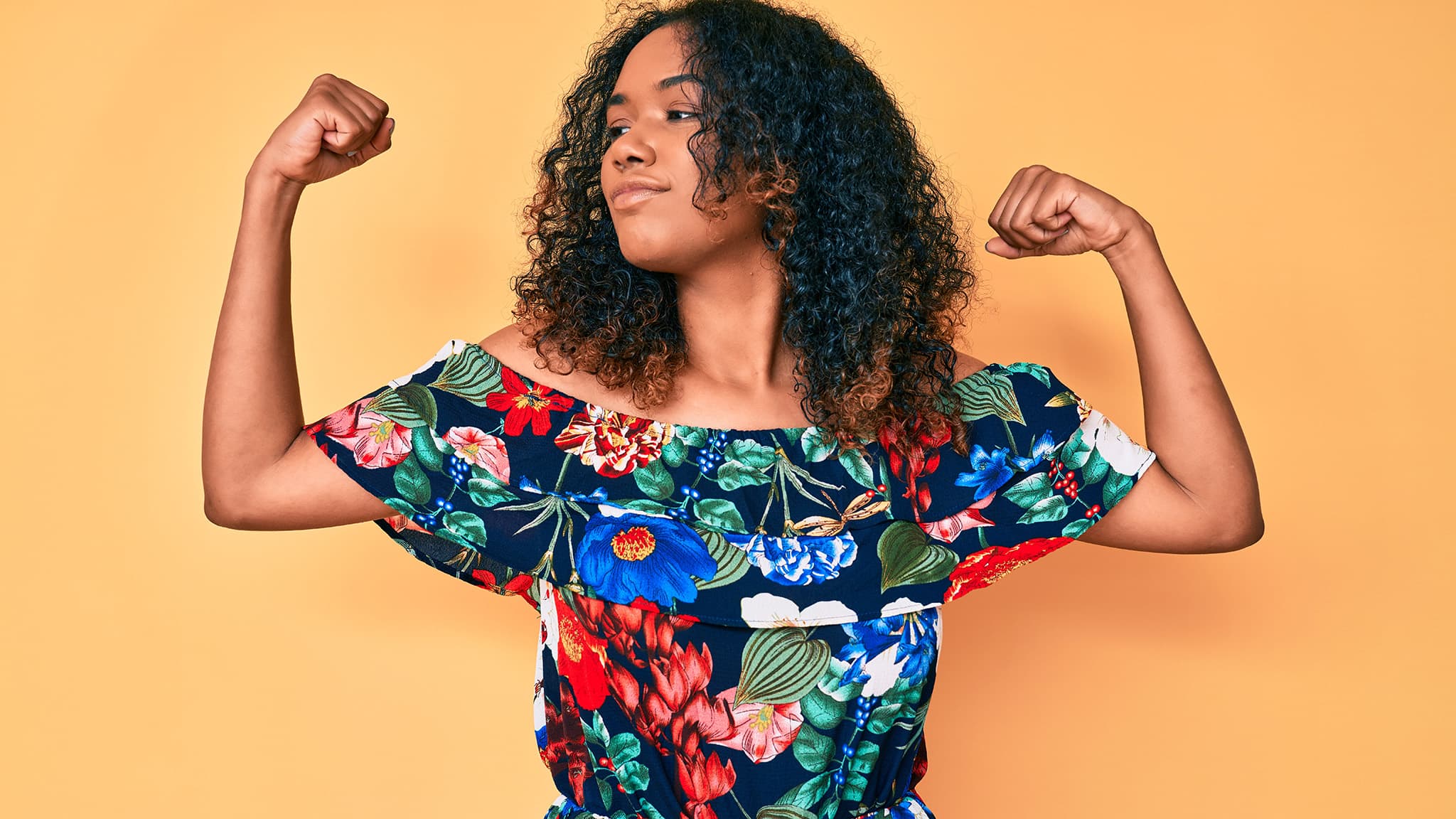 Photo Of Black Woman Flexing Her Arms Looking To Her Right, Feeling Strong