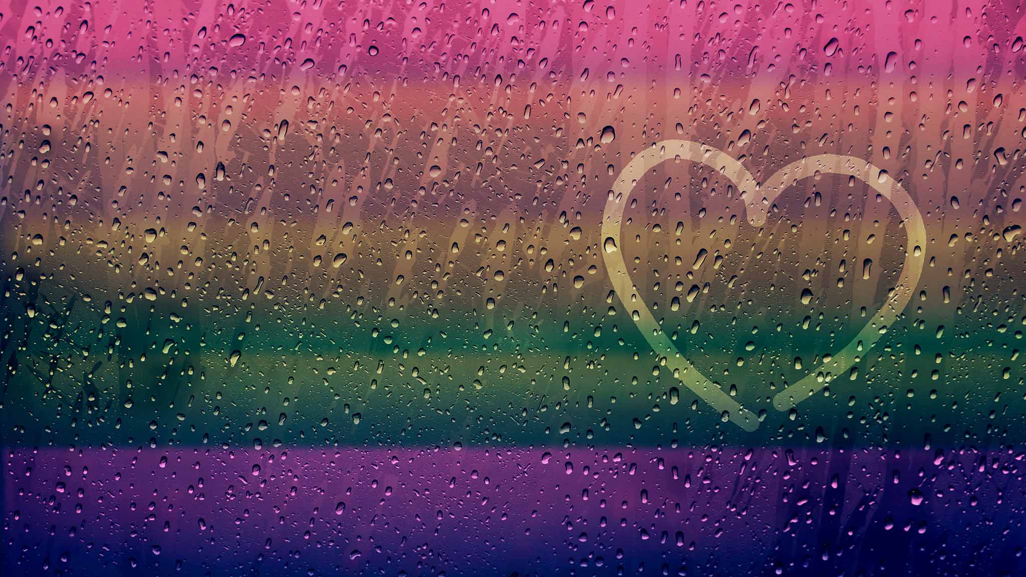 Why Do Gay Men Often Deal With Feelings Of Loneliness? Finger-Drawn Heart Shape On Rainy Window Surface With A Rainbow Cast