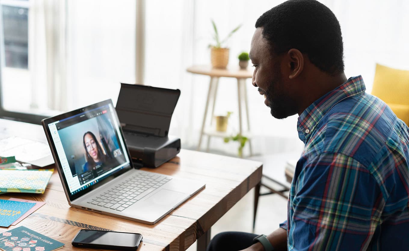 Photograph Of Man Smiling And Interacting With Woman On His Laptop Screen, Virtual Socialization Concept
