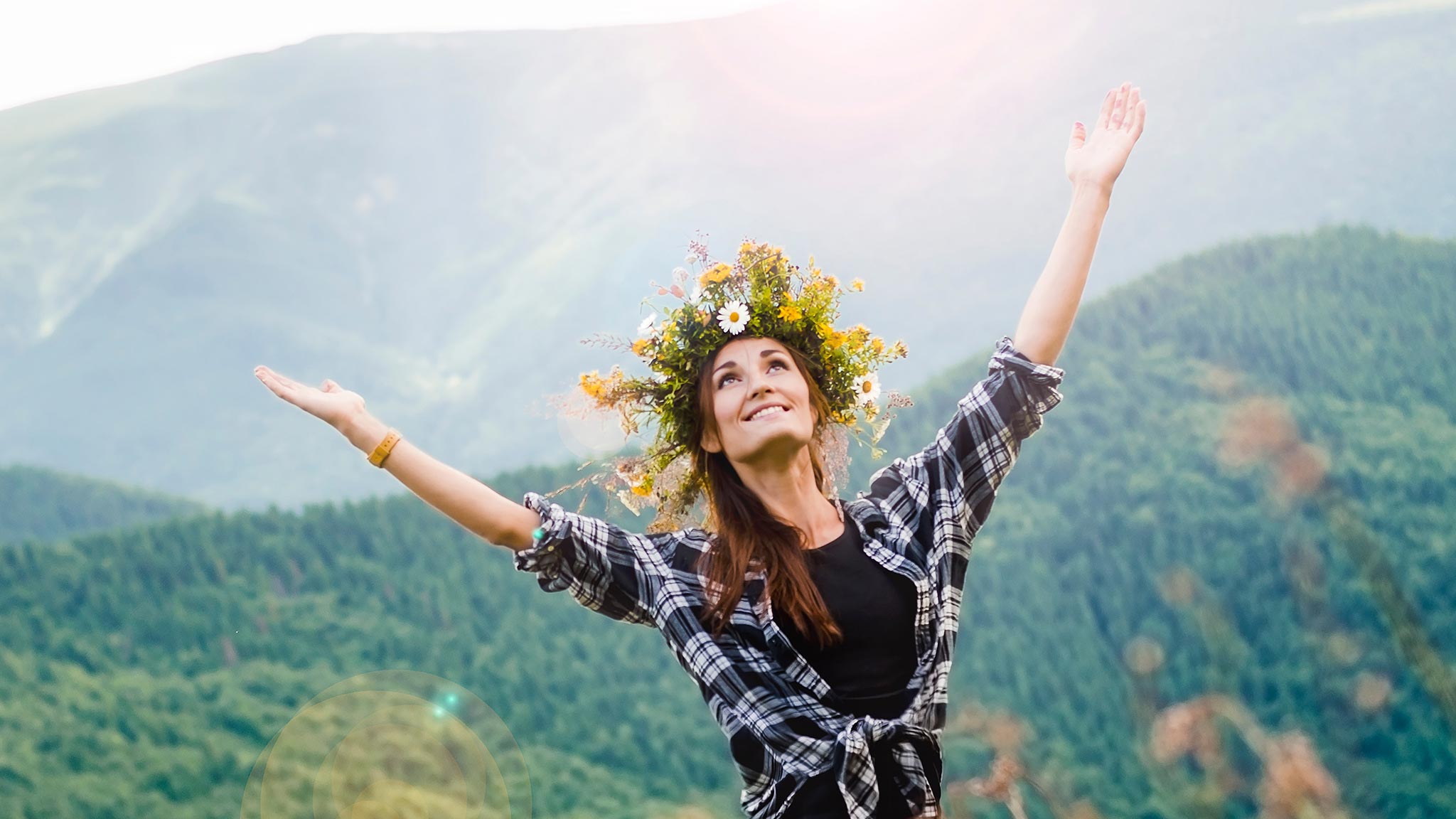 Photograph Of Woman Wearing Flower Headdress, Hands Raised Toward The Sky In Happiness In Countryside Setting