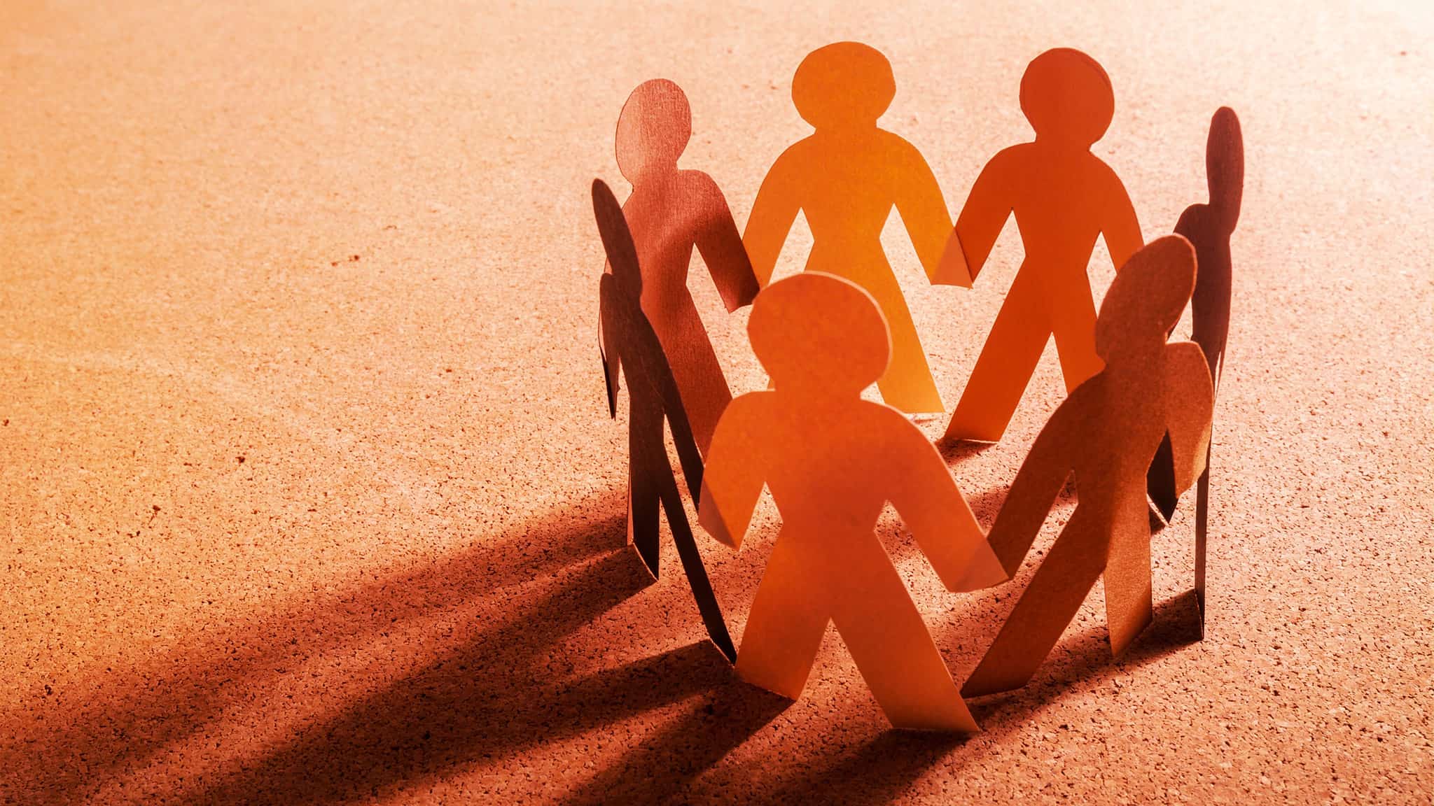 Resources And Help For Crises, Mental Health, And Loneliness Sunset-Shadowed Lighting On Paper Cut-Outs Depicting People Holding Hands In A Circle, Help And Support Concept