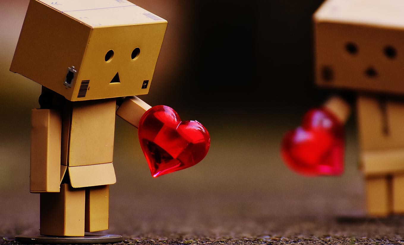 photo of tiny cardboard character holding a red heart and looking sad due to being sexually lonely