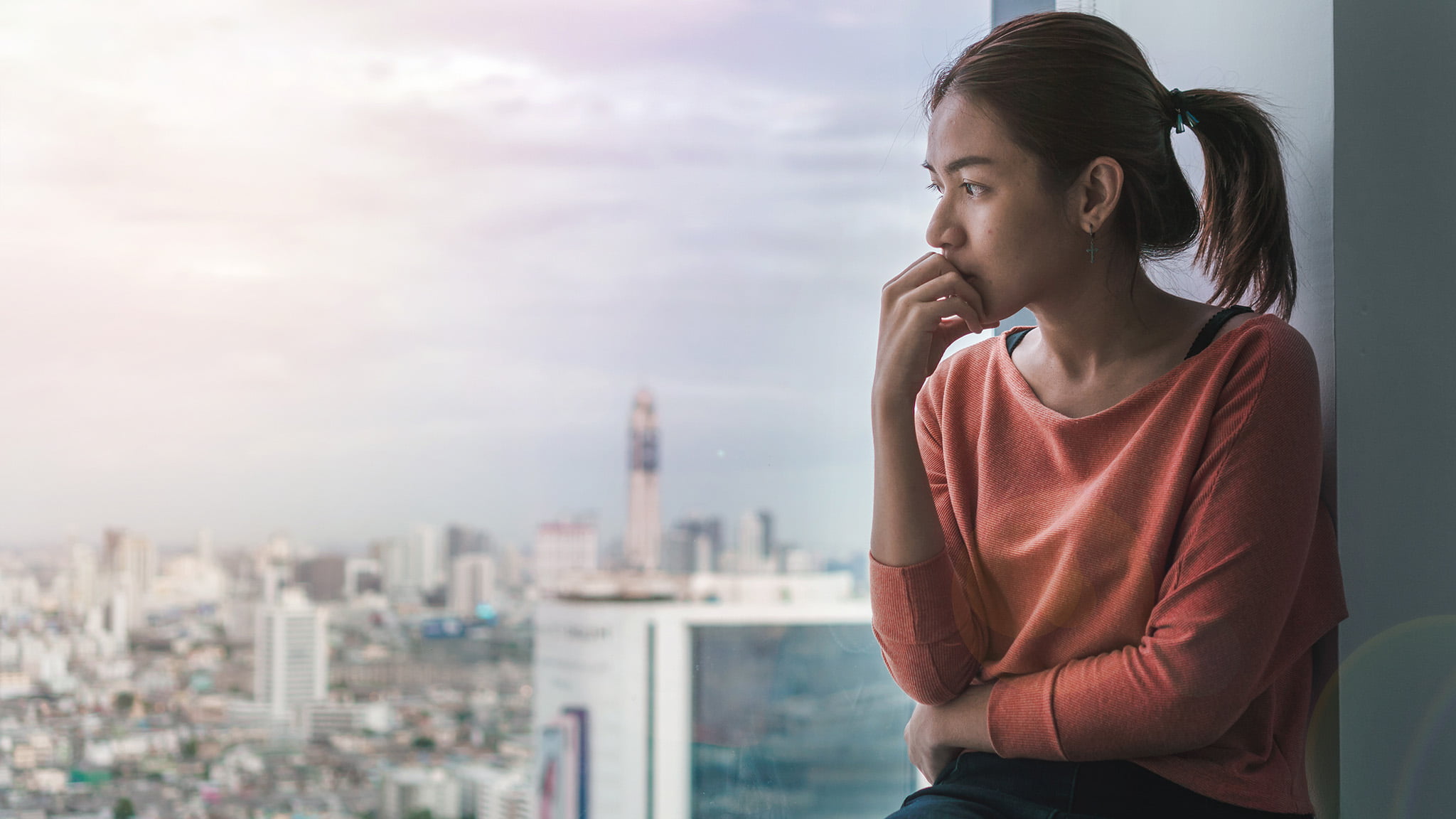 Image Of A Woman Looking Out Of The Window At The City