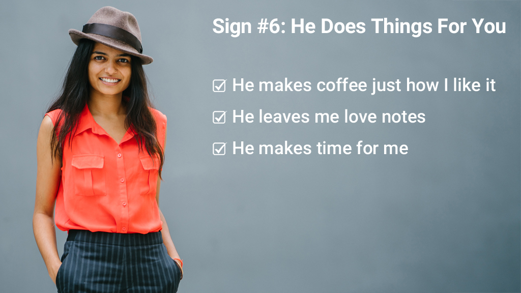 Indian Woman Smiling Wearing a Hat Against Grey Background With Signs A Man Does Things For You