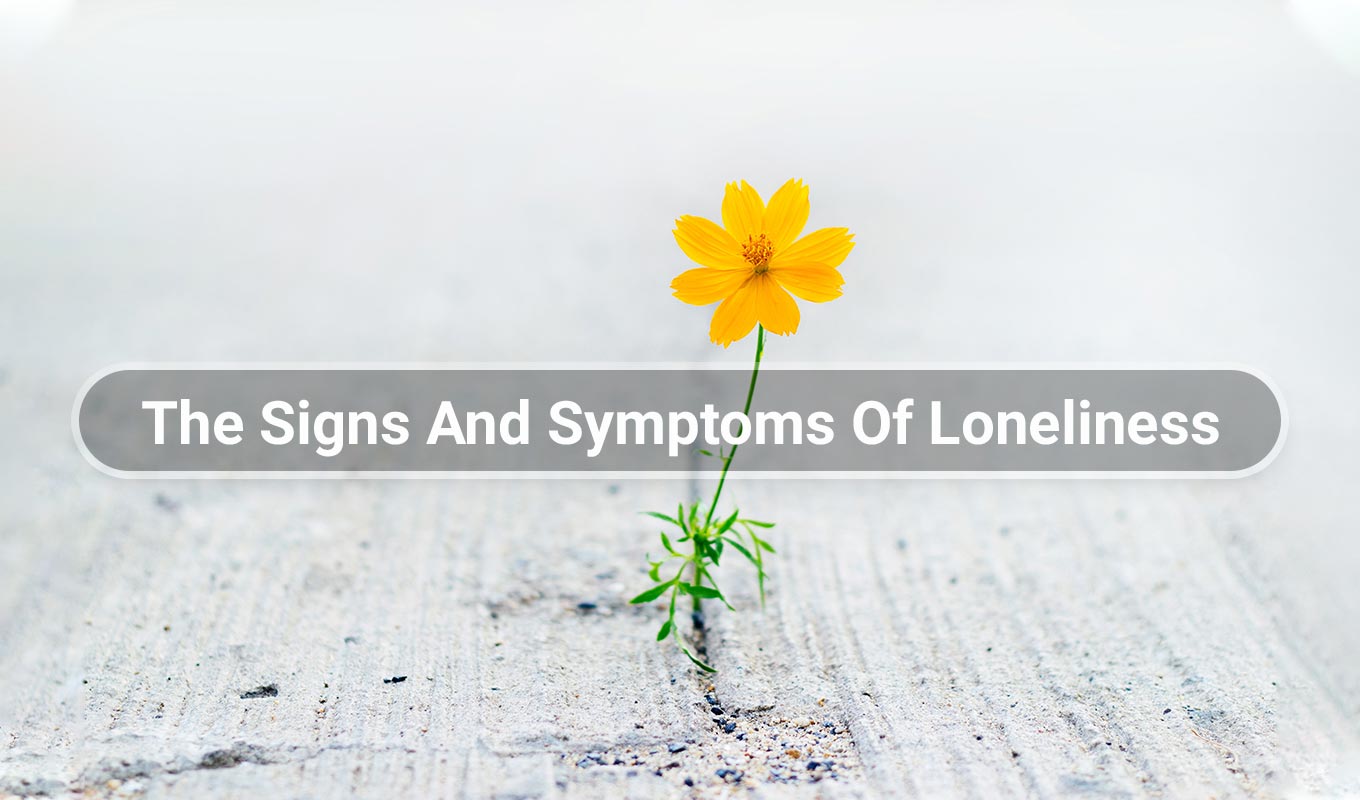 yellow flower growing through crack in the pavement with text overlay that reads the signs and symptoms of loneliness