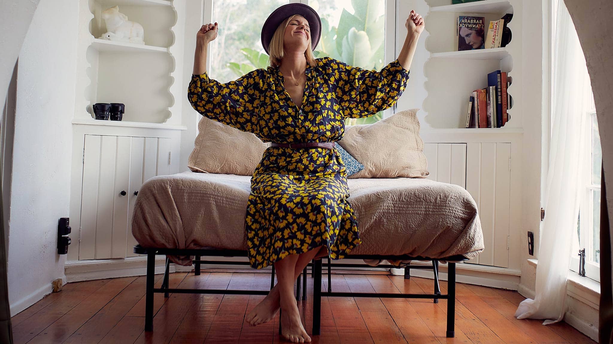 Photograph Of Happy Woman Dancing Alone While Sitting In A Comfortable Room At Home