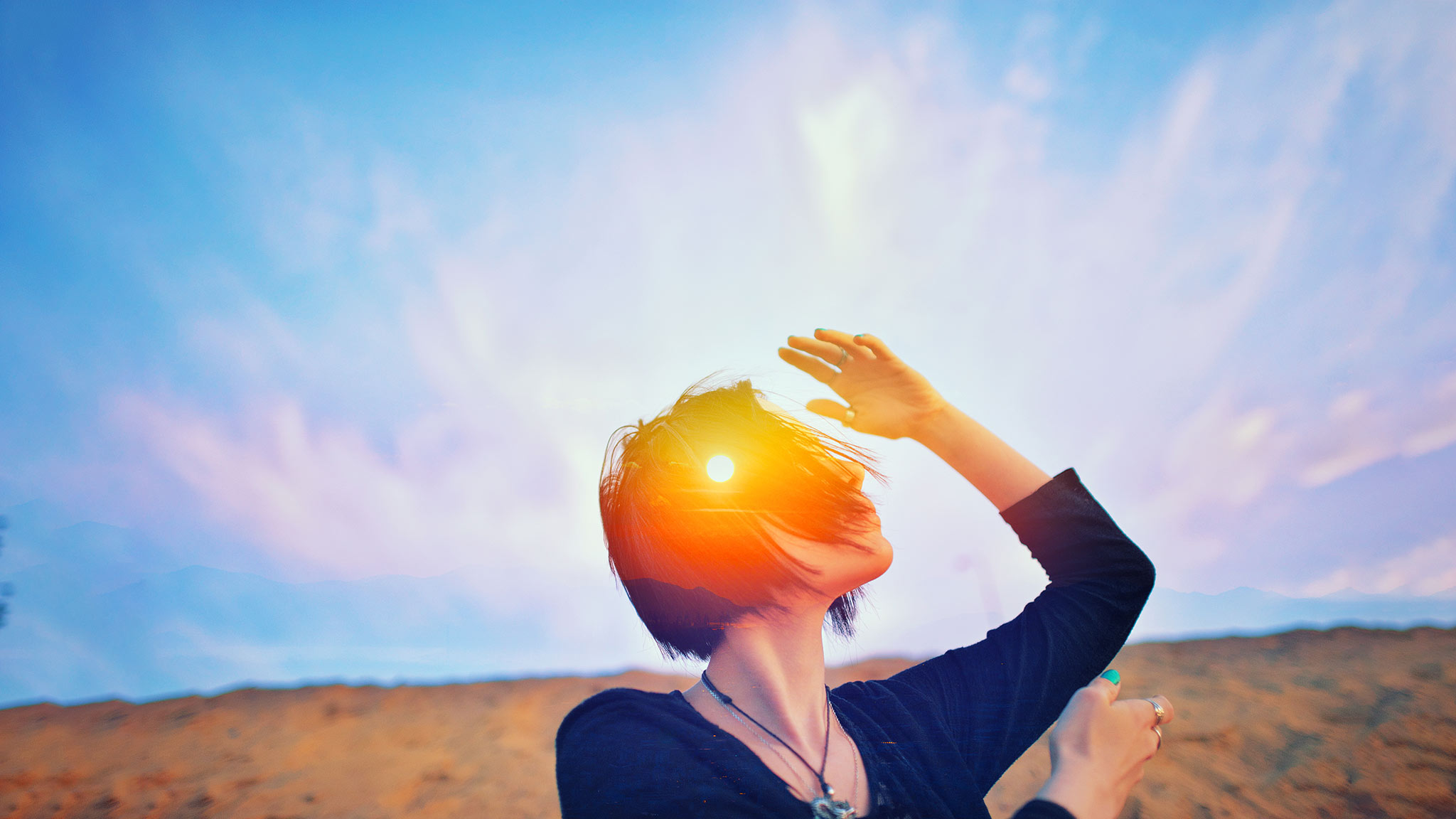Head And Shoulders Photograph Of Woman Dancing On Beach With Sunrise Superimposed Over Her Head, Enlightenment Concept