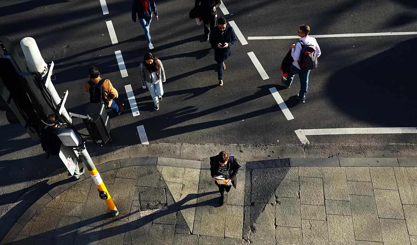 Aerial Photograph Of Many People Walking Through Busy City Street Intersection