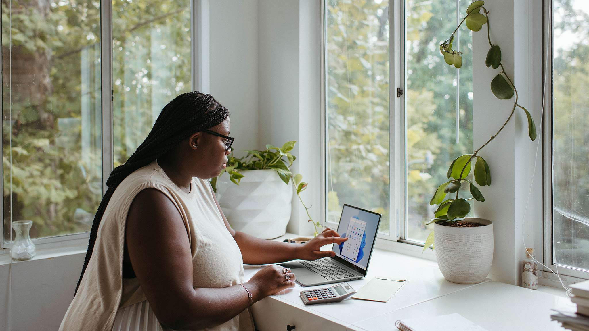 Photograph Of Woman Sitting Alone In Home Office, Working At A Laptop Computer